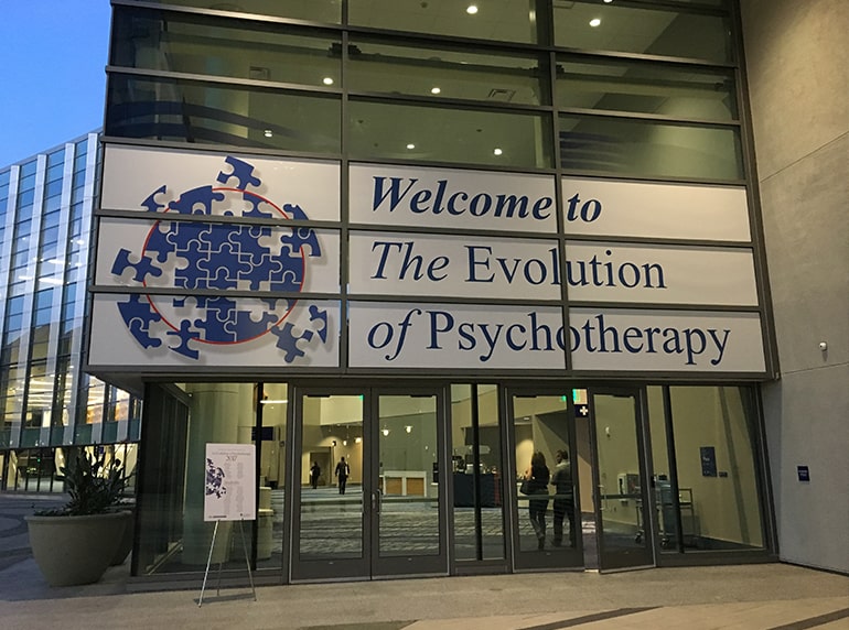 The exterior of a building with a sign that says Welcome to The Evolution of Psychotherapy