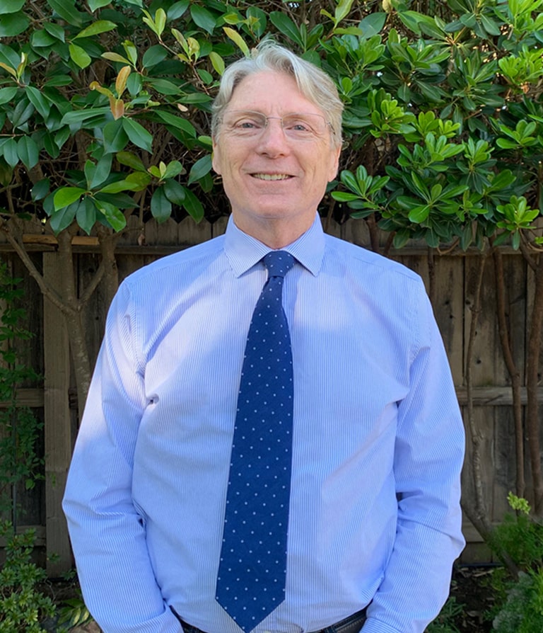 Stephen Diggs wearing a blue button up with dark blue tie